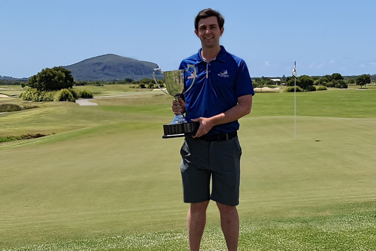 An excited Luke Parker displays the Carnegie Cup, the trophy for winning the Queensland PGA Trainee Championship
